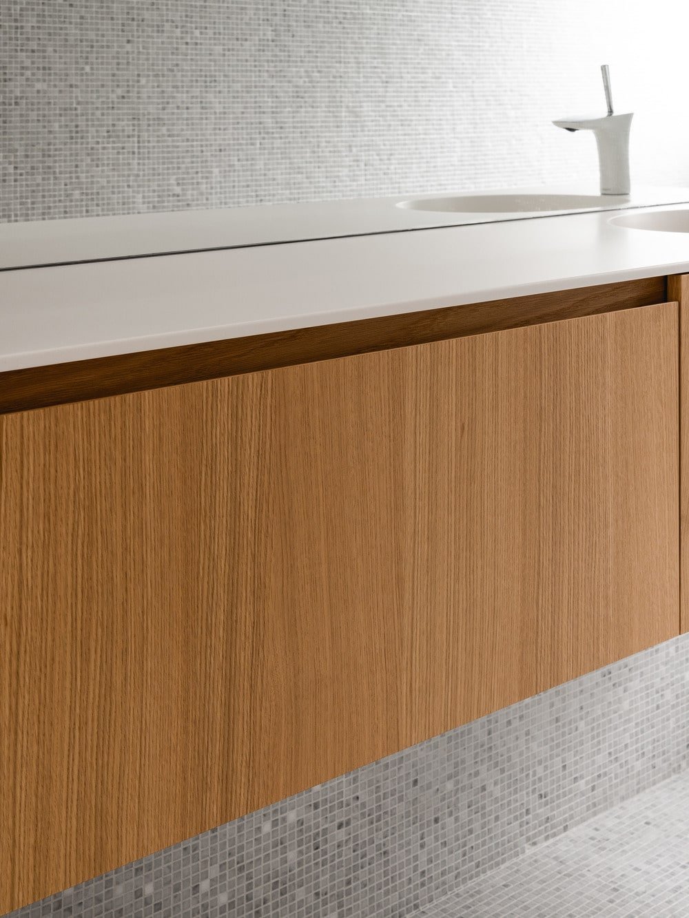 This is a close view of the floating shelf that has a wooden tone to contrast the light wall.