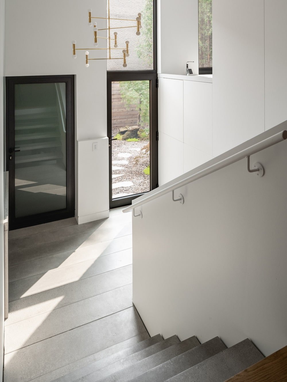 This is the simple foyer upon entry of the glass main door topped with a set of modern decorative chandelier.