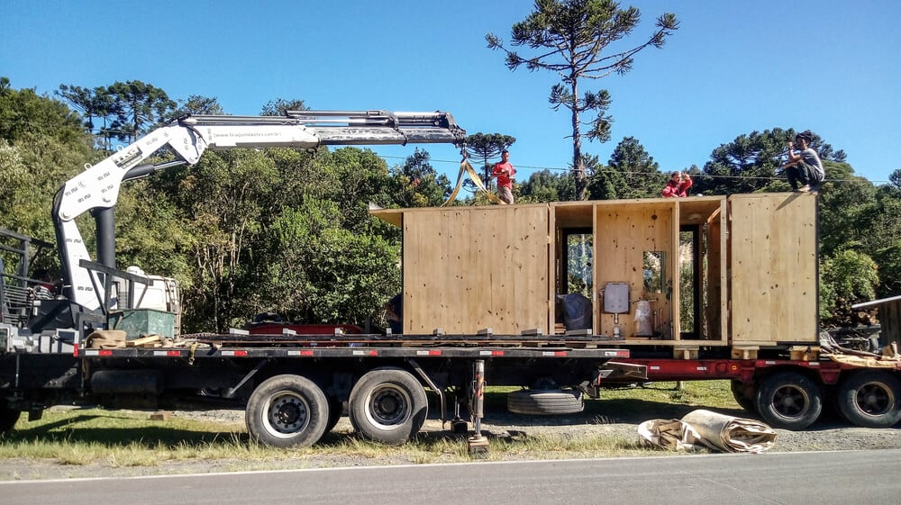 This is a view of the house during construction with its parts being delivered on a truck.