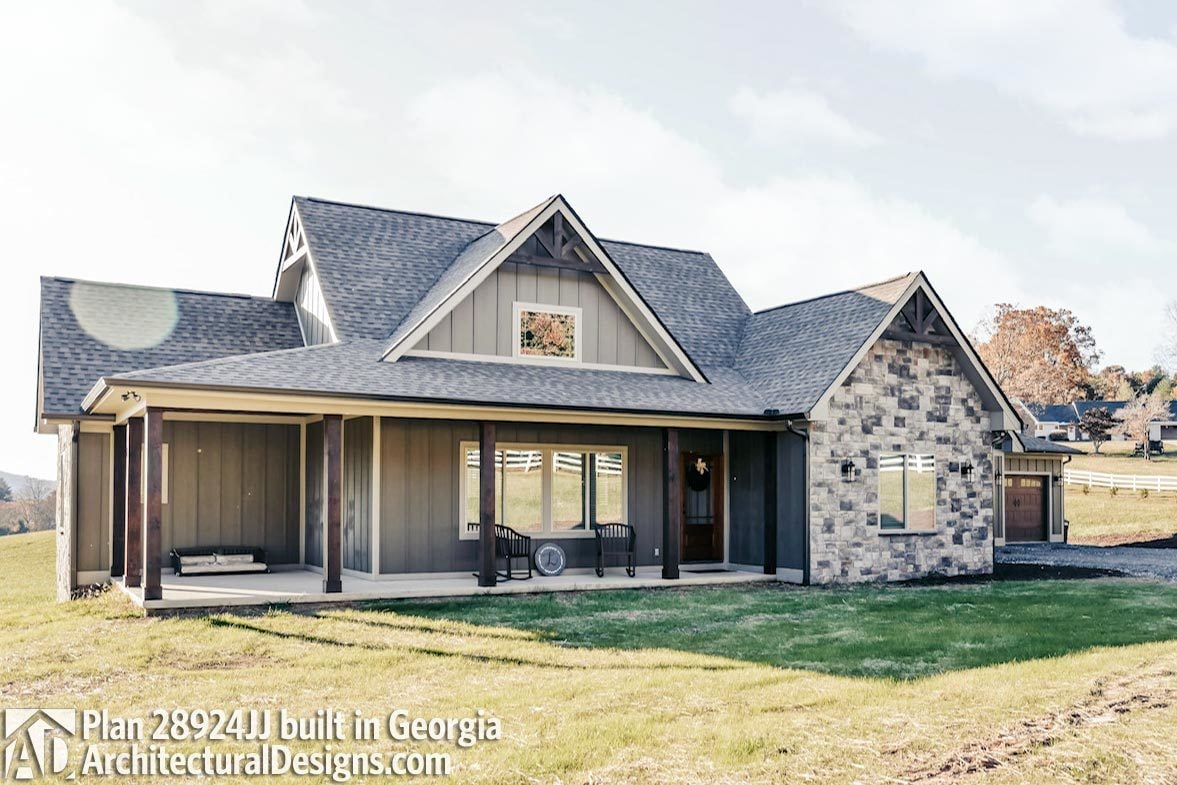 Another alternate exterior featuring a board and batten siding, stone accents, covered porch, and gable roofs adorned with rustic trims.