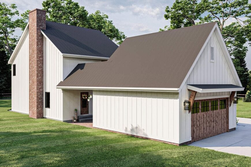 The garage is attached to the home's rear. It has the same siding plus a wooden garage door.
