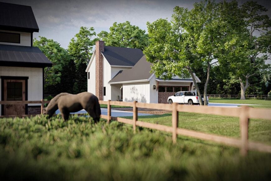 View of the house from the backyard showing the garage and lush lawn surrounding it.