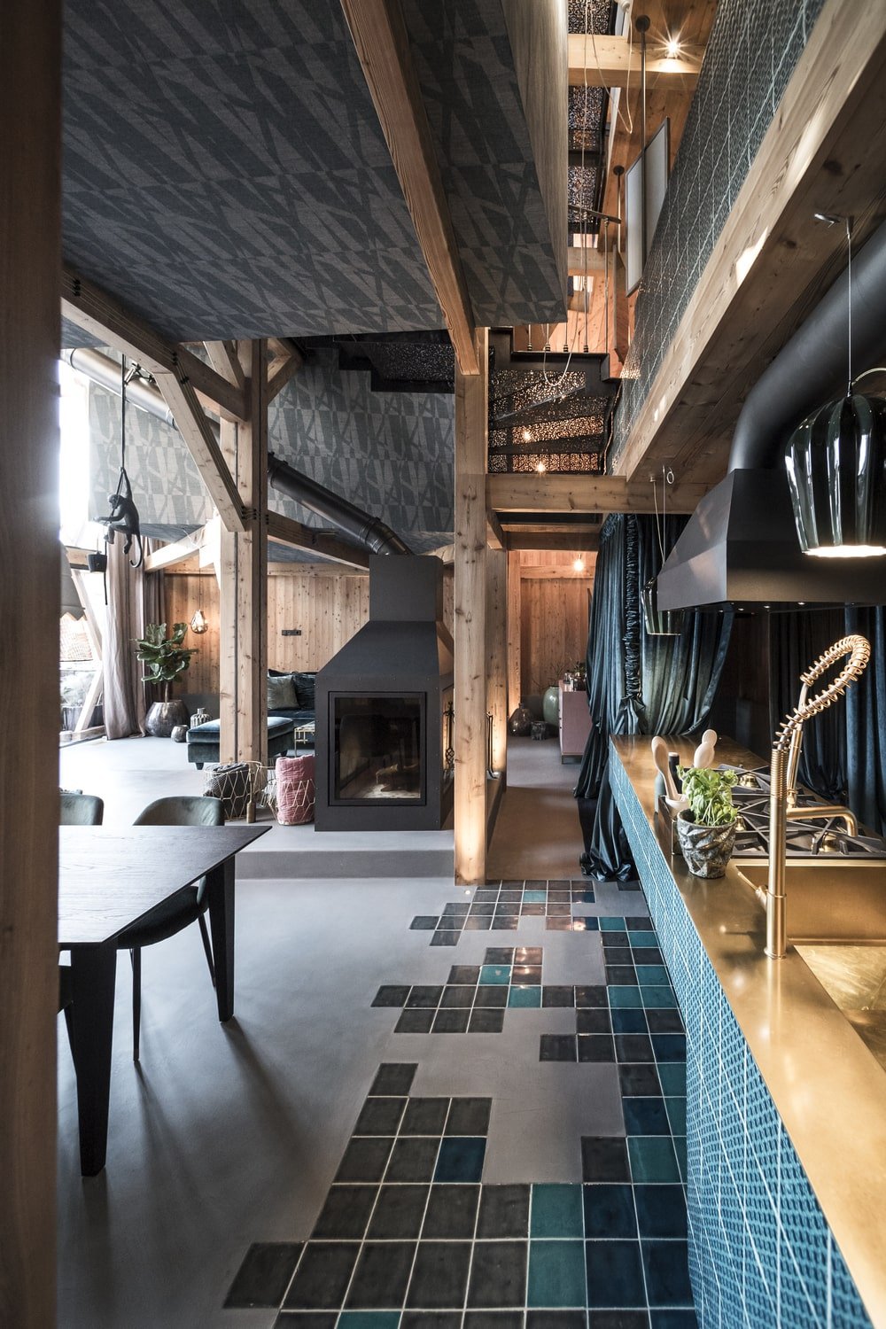 This view showcases the proximity of the kitchen peninsula and the dining area as well as the small decorative tiles on the floor.