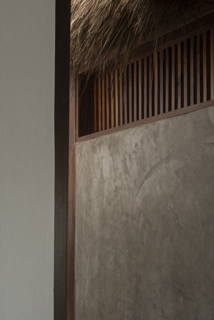 This is a close look at the slat wooden windows above the walls for ventilation.