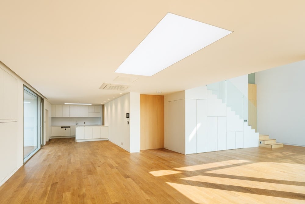 This is an interior view of the house showcasing a large open room with a skylight in the middle.