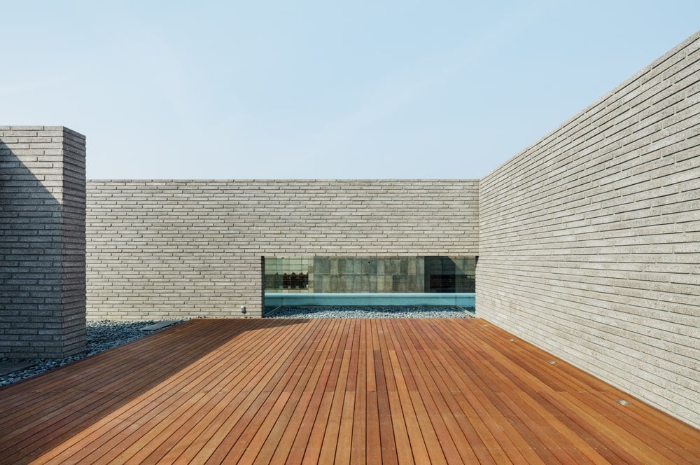 The rooftop terrace of the house has wooden deck flooring.