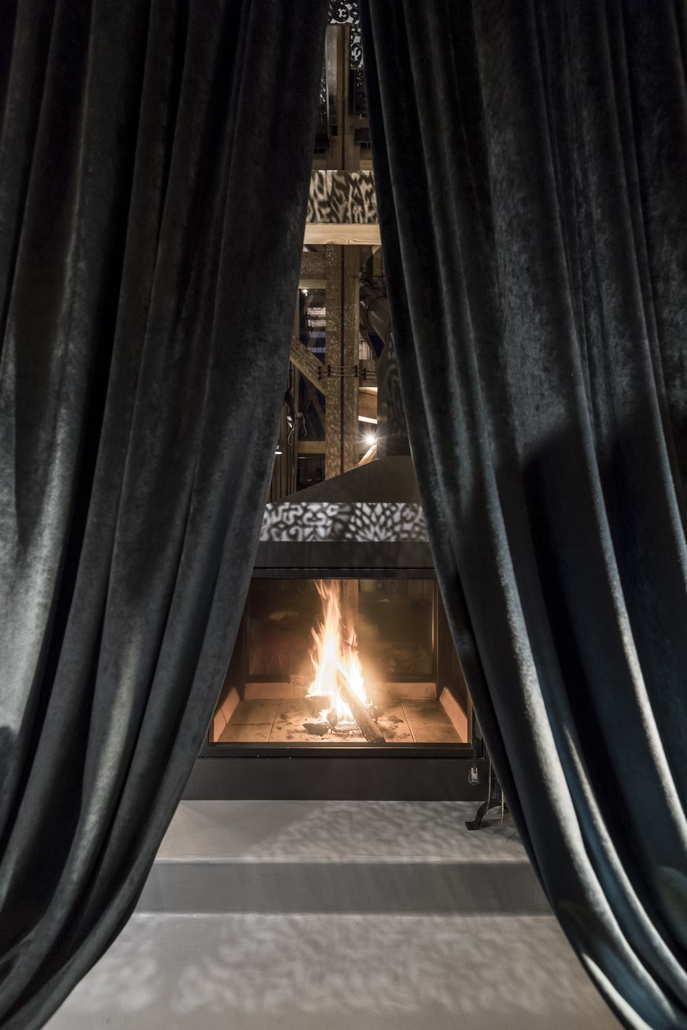 This is a close look at the large fireplace with intricate designs on it.