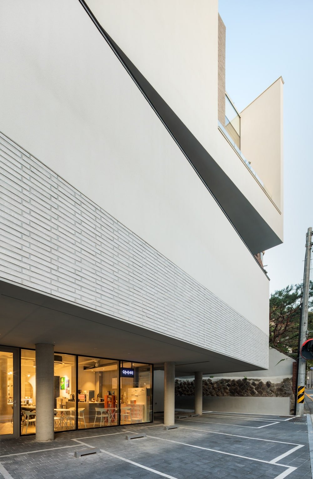 The wall above the main entrance of the building has a wall tile accent to it resembling bricks.