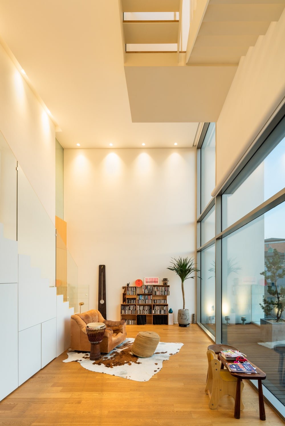 The interior has a tall ceiling with beige walls that match and complemented by recessed lights.