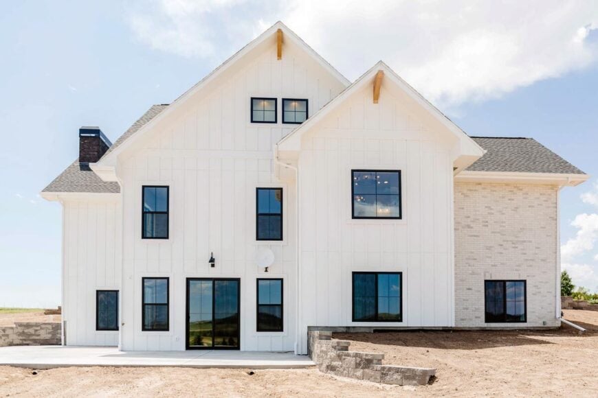 Left exterior view with lots of tinted glass windows and gable rooflines graced with decorative brackets.