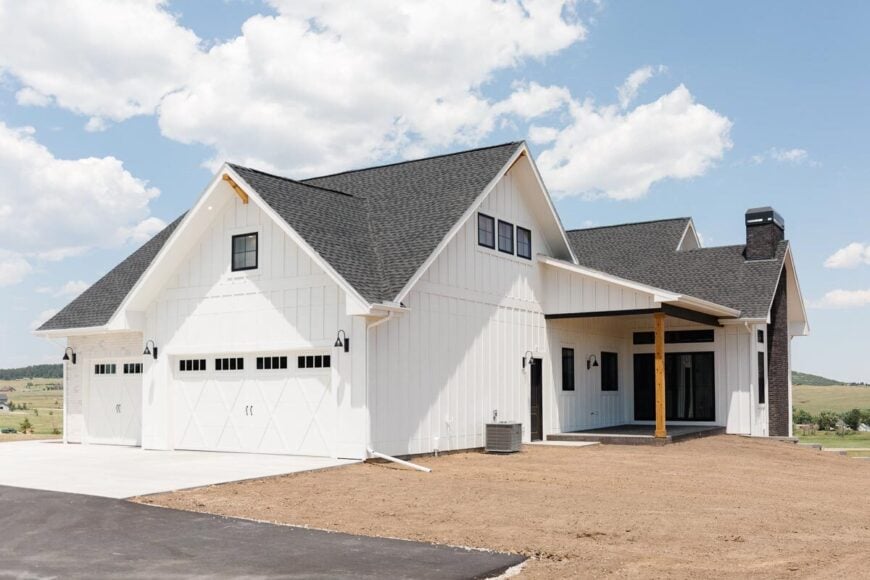 The right side shows the 3-car garage enclosed in pristine white garage doors.