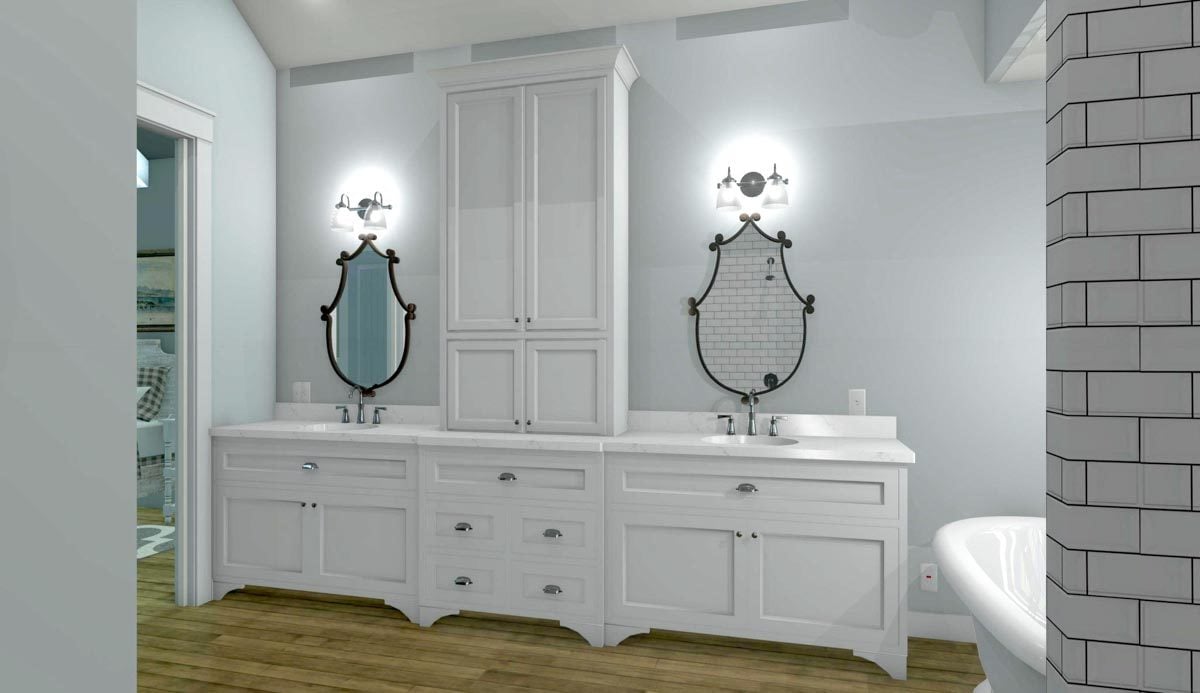 The dual-sink vanity is paired with decorative mirrors and glass sconces.