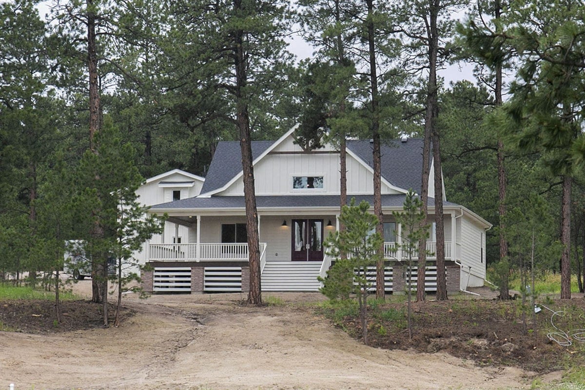 Spacious Porch Welcomes Visitors to Timber-Lined Home