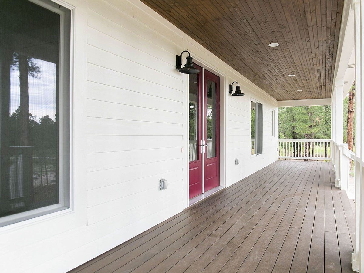Inviting Porch with Bold Red Accents and Verdant Views