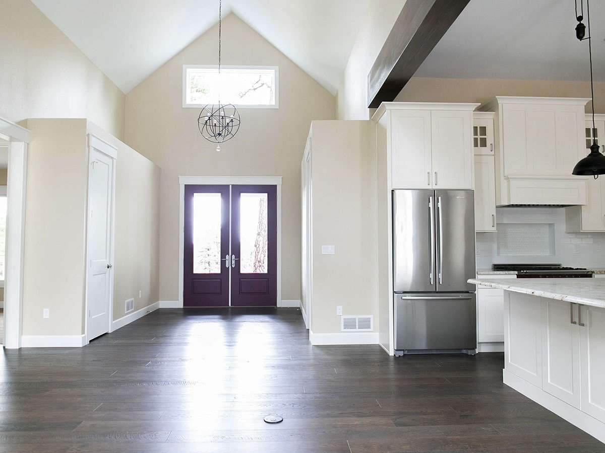 Inviting Living Area with Glass Double Doors and Vaulted Ceiling