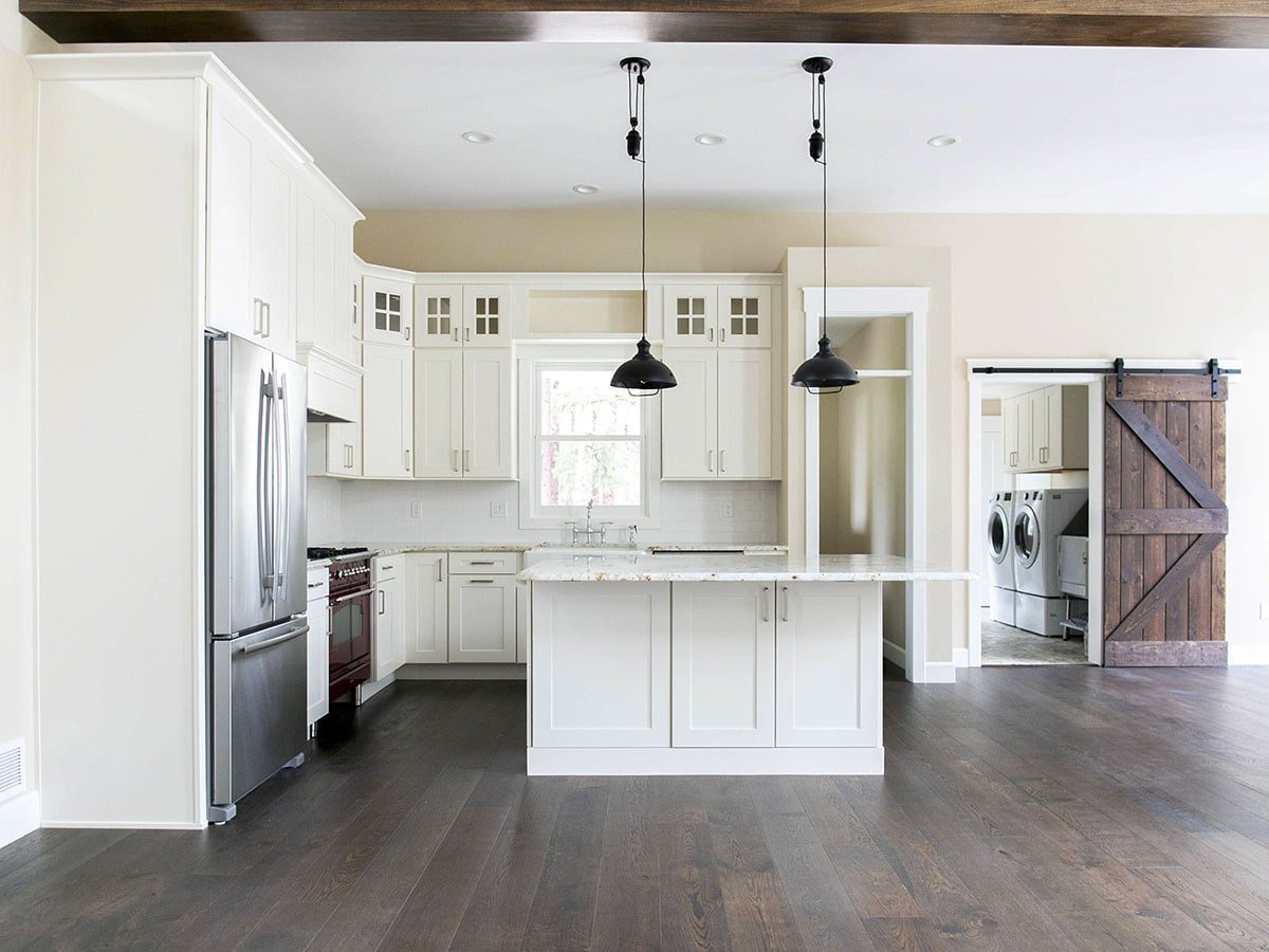 Sleek Kitchen Design with Barn Door Laundry Access