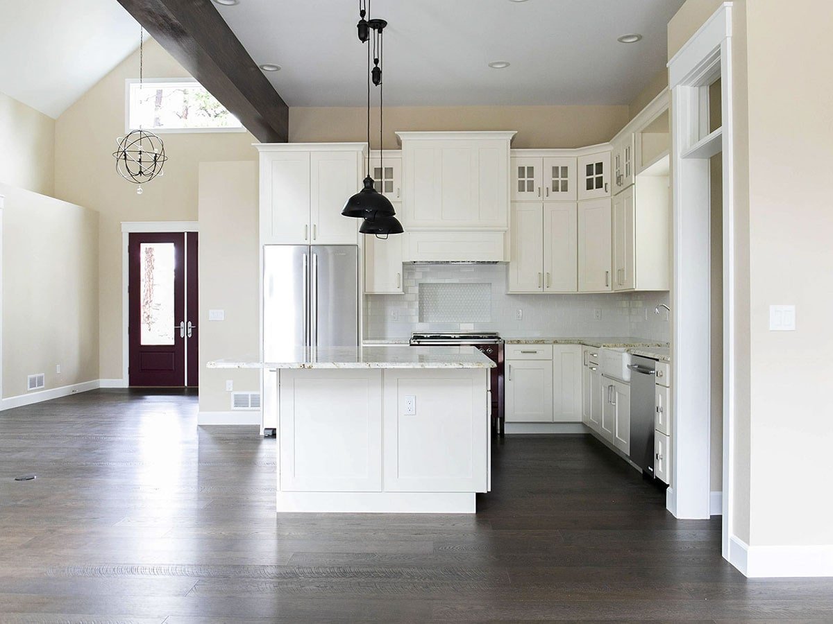 Sleek Kitchen-Living Area with Bold Maroon Accent