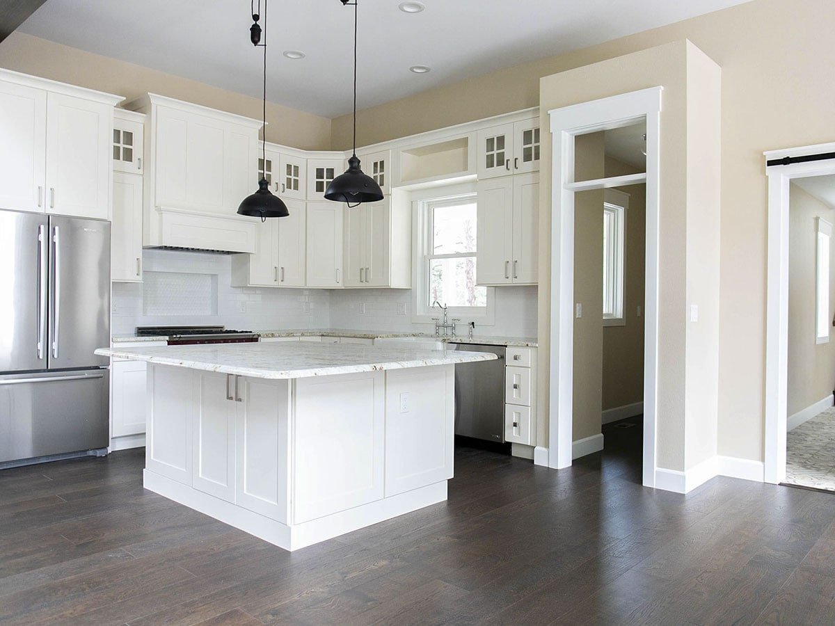 Sleek Kitchen Showcasing White Cabinets and Marble Island
