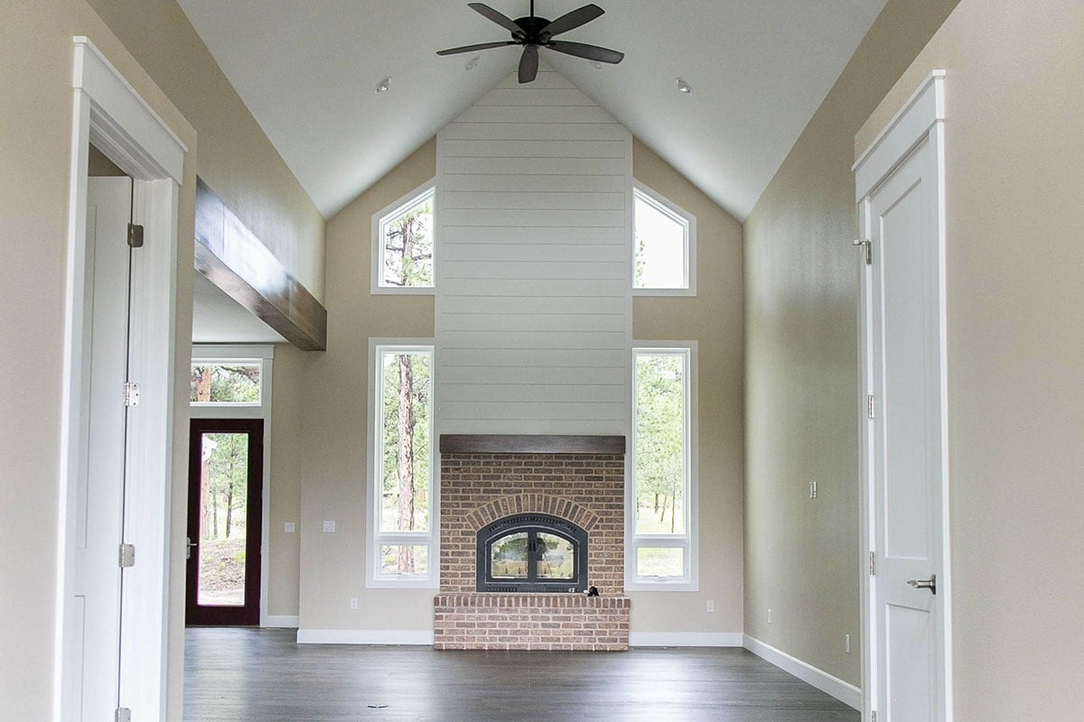 Expansive Room With Vaulted Ceilings and Brick Fireplace