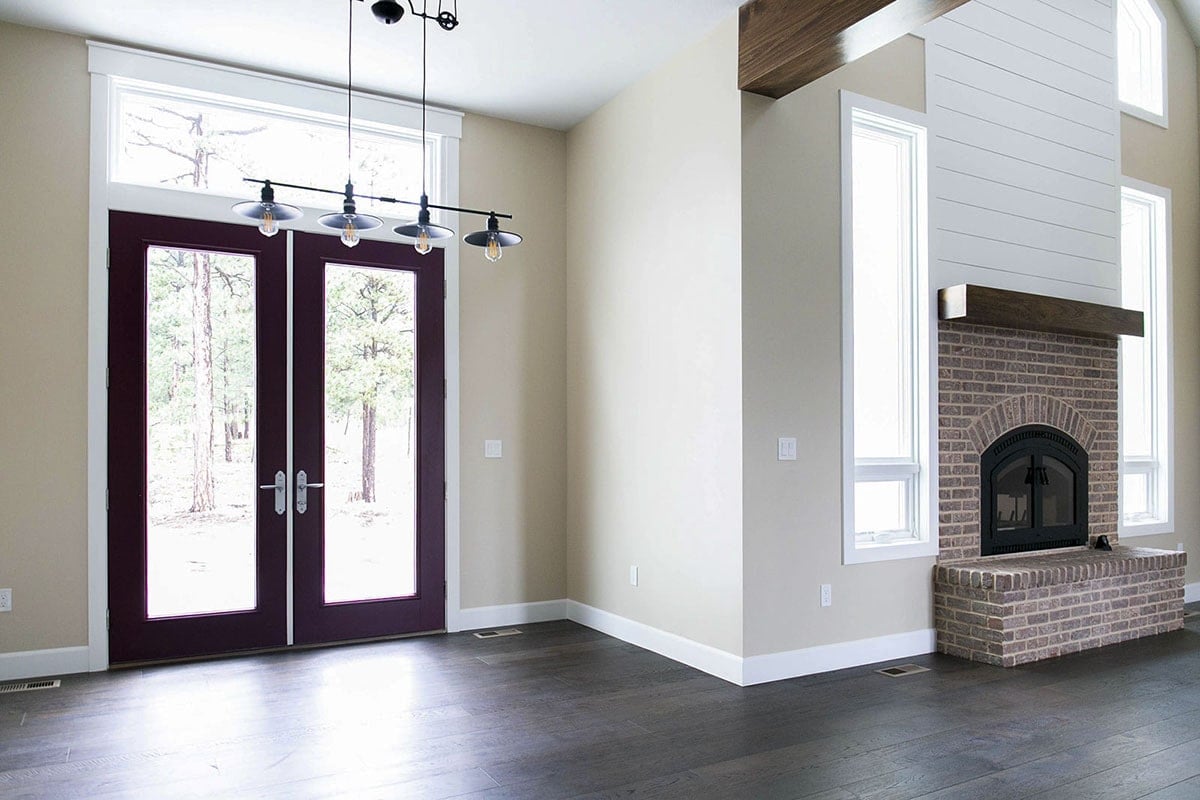 Inviting Lounge with Striking Brick Fireplace and Double Doors