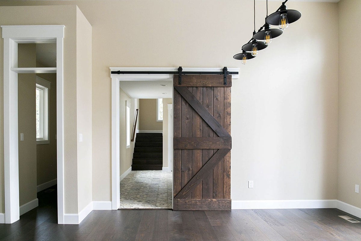 Dark Wood Barn Door Enhances Elegant Home Interior