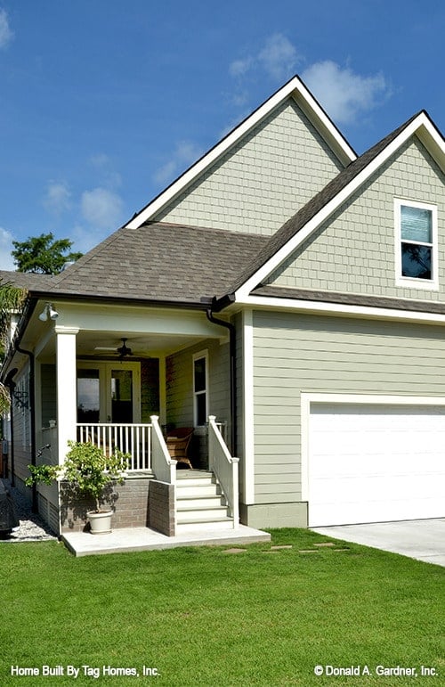 Inviting Green-Faced Home with Classic White Accents