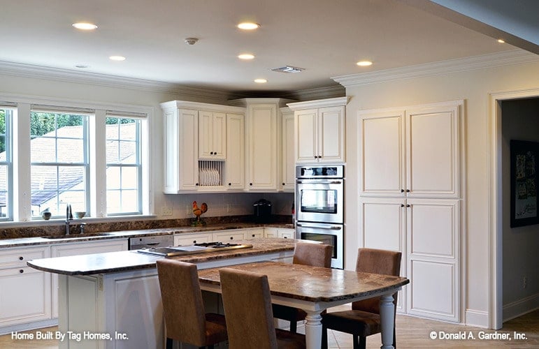 Bright Kitchen with Integrated Appliances and Central Dining
