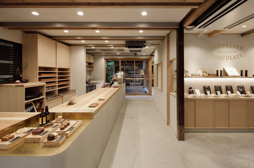 A few steps from the cabinetry and counters is the large reception and bar area with a large L-shaped peninsula with light wooden counters.