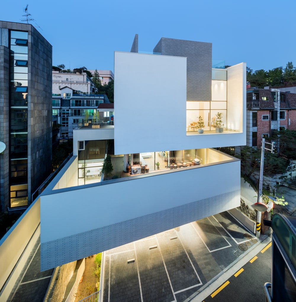 This is an aerial view of the building with a focus on the warm glow of the glass walls.