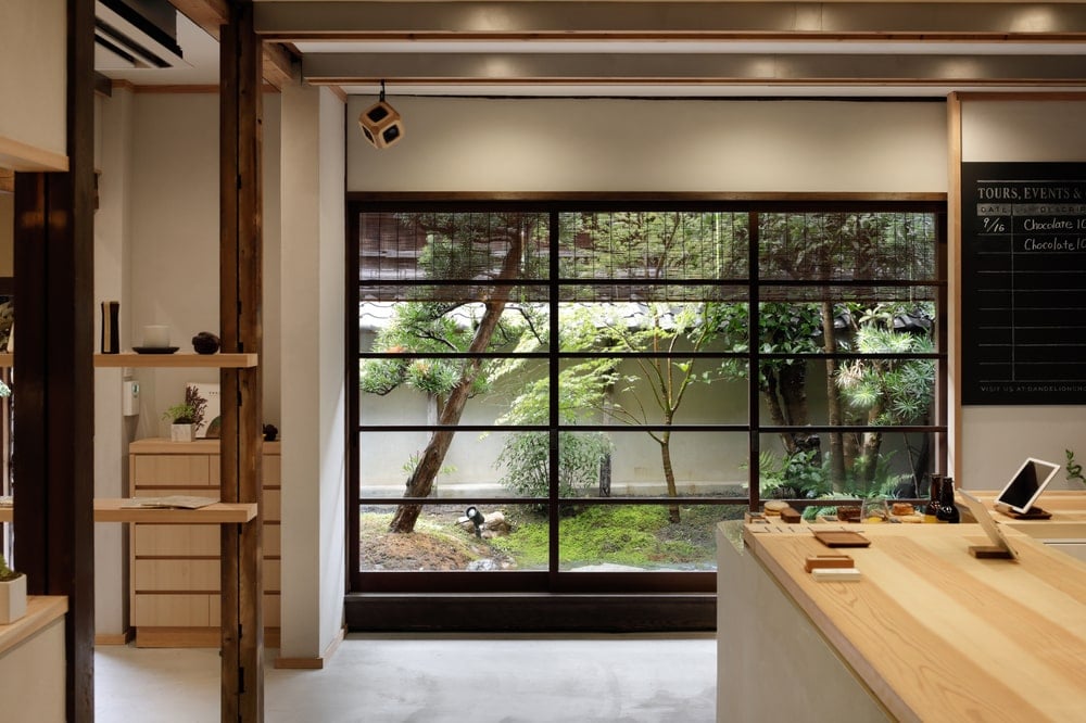 This is a look at the interiors that has wood-top counters and large glass walls that show the zen garden landscape outside.