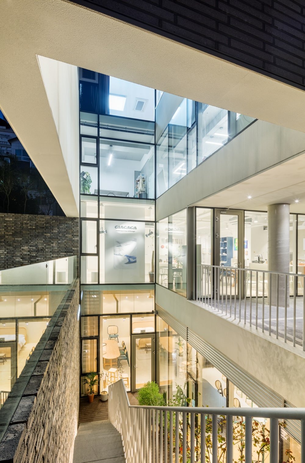 This is a closer view of the area with a set of steps to the lower level, metal railings and glass walls.