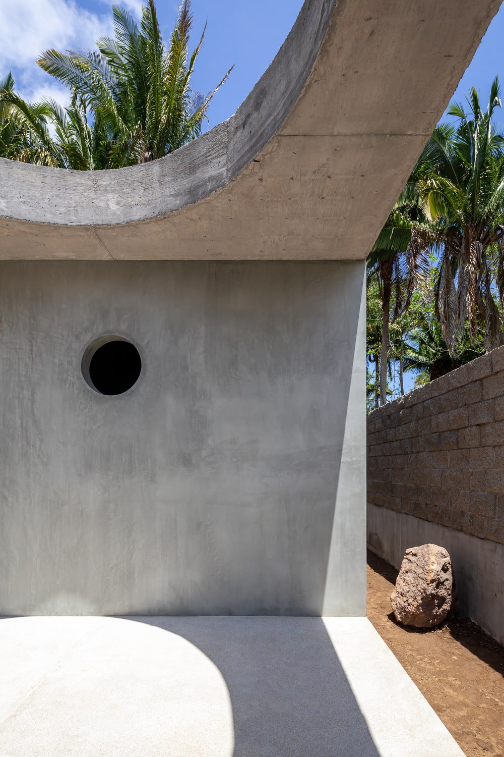 This is a close look at the concrete wall with a round hole that serves as a ventilation window.