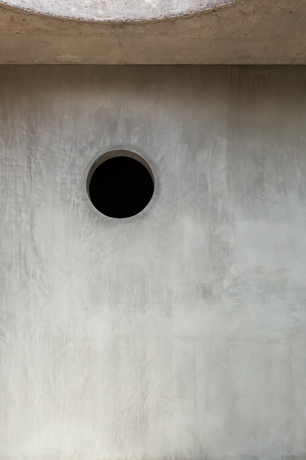 This is a close look at the round hole at the upper portion of the concrete wall to serve as ventilation.