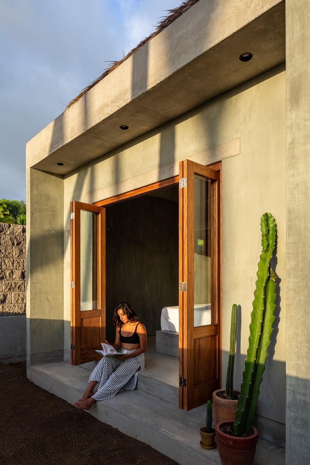 The side of the folding doors is adorned with a variety of cacti in pots.