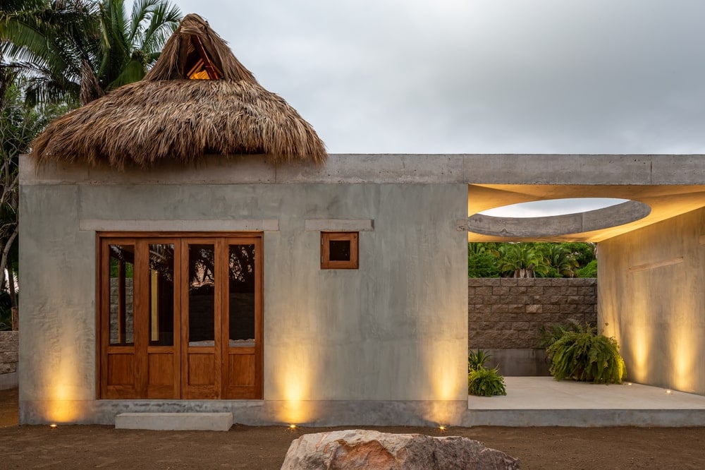 This is the exterior of the house with the folding doors closed and exterior lights on.
