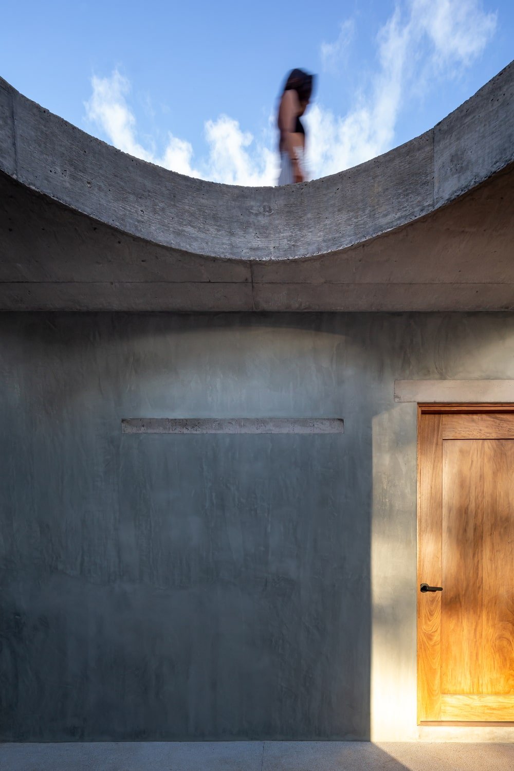 This is a close look at the concrete wall that pairs well with the wooden door of the bedroom.