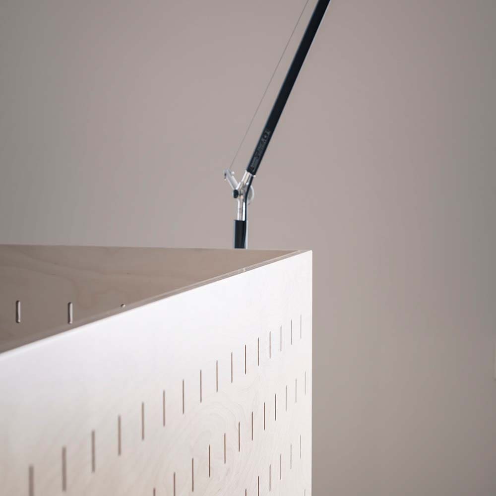 This is a close look at the wooden divider and back rest of the built-in bench paired with the dining table.