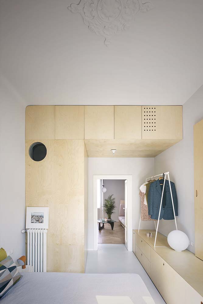 This is the bedroom that has a large wooden structure on the side of the bed complemented by the the on the foot of the bed.