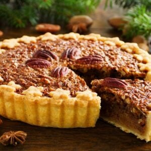 A full pecan pie with a slice.