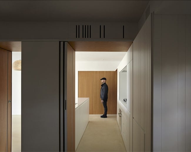 This view of the kitchen shows that it can be closed off on one sidewith a couple of folding wooden doors that lead to the kitchen peninsula.