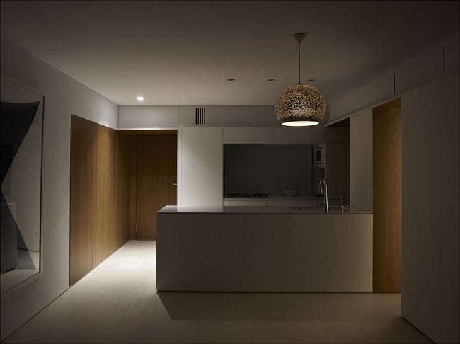 This is a view of the kitchen when the lights are off showcasing the light of the pin lights and dome pendant light.