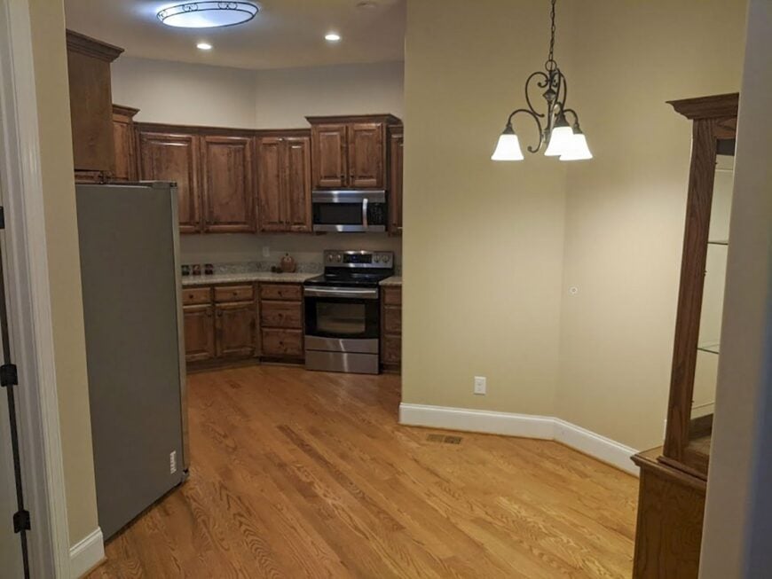 There's also a fridge and cooking range nestled between the wooden cabinets.