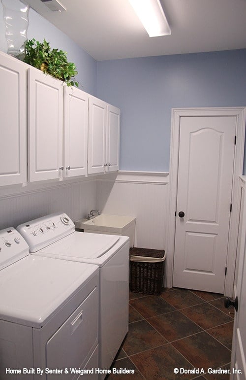 Efficient Laundry Room with Functional White Cabinets