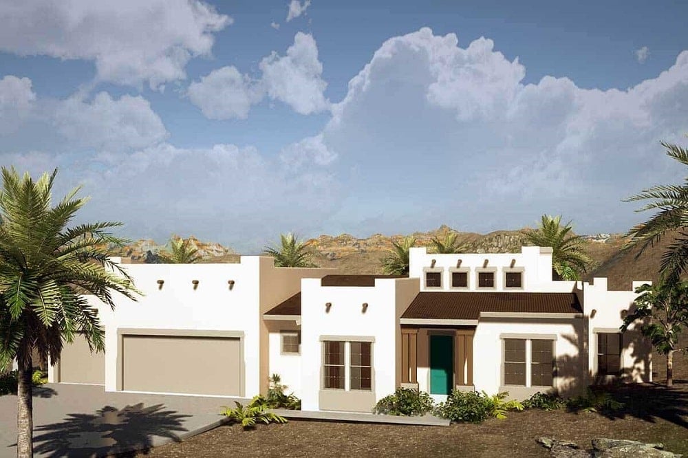 This is a Santa Fe style Adobe home with a large garage door on the left and dark brown accents to its bright beige exterior walls.