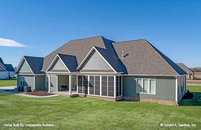 Rear exterior view showing the screened and covered porches framed with white trims.