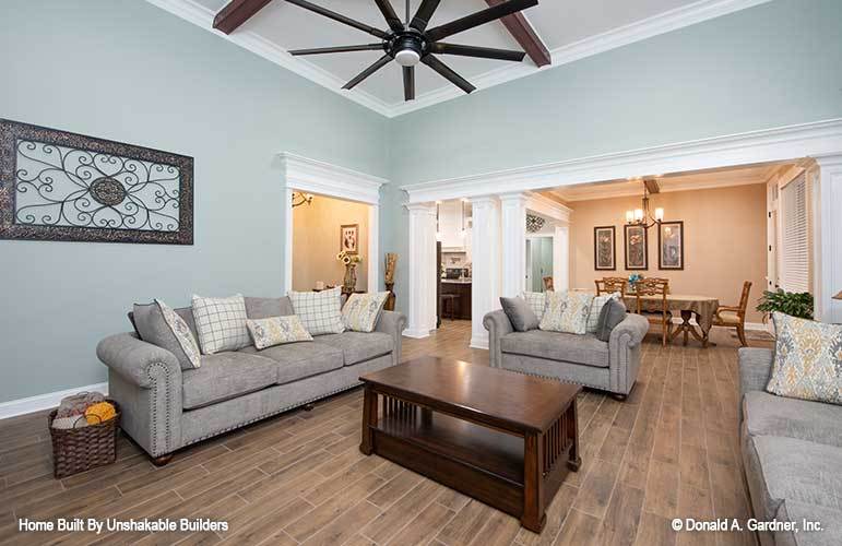 The living room opens to the dining area defined by interior columns.