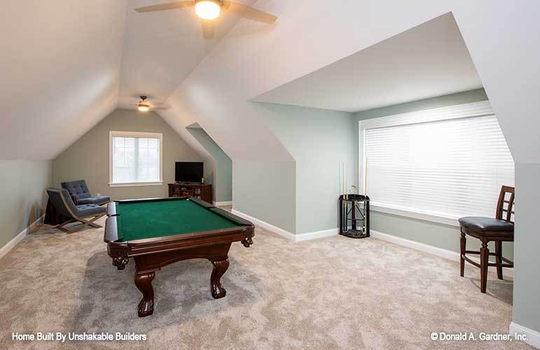 Bonus room with a vaulted ceiling and a billiards table over carpet flooring.