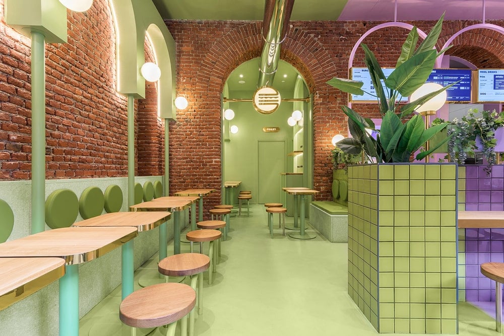 This is the side of the restaurant with rows of tables and chairs adorned by the red brick, arches and the avocado green tone on the floor, ceiling and the wall accents.