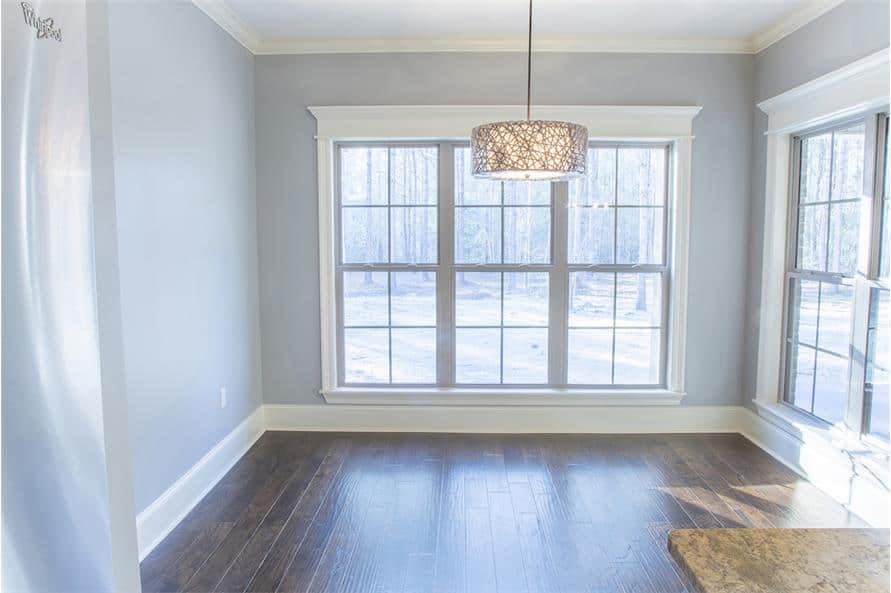 White framed windows surrounding the breakfast nook flood the eat-in kitchen with natural light.