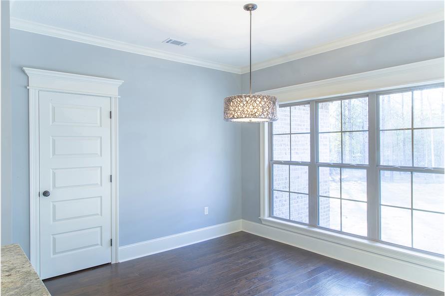 A nearby white door conceals the walk-in pantry.